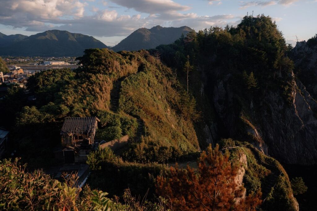 A breathtaking view of the Uradome Coast nature trail winding throughout the hills and abandoned buildings